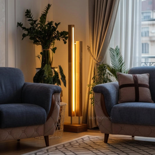 Modern living room with blue armchairs, a floor lamp, and decorative plants.
