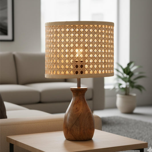 Wooden table lamp with a patterned shade on a table in a living room.