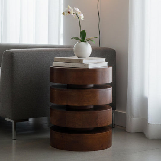 Wooden side table with books and a flower pot in a living room setting